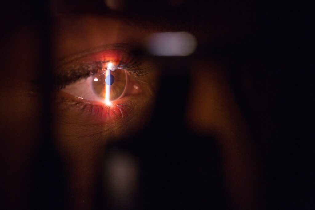 eye looking into equipment with a band of light
